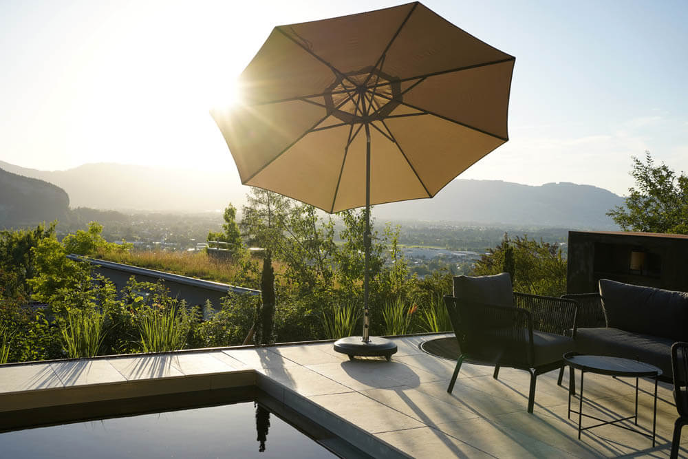 Sunshade contre-jour at a stylish flagstone pool terrace